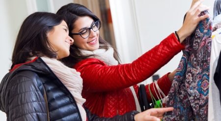 two-beautiful-girls-shopping-clothes-shop_1301-6701